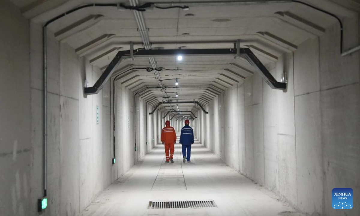Technicians patrol inside the emergency access of a shield tunnel along the east sixth ring road in Beijing, capital of China, April 20, 2025. A renovation project on Beijing's east sixth ring road was opened to traffic upon full completion on Sunday. The renovated section is about 16.3 kilometers in length, including a 7.4-kilometer-long shield tunnel. The project helps improve expressway transport across the core area of Beijing's sub-center Tongzhou District. (China Railway 14th Bureau Group Co., Ltd./Handout via Xinhua)