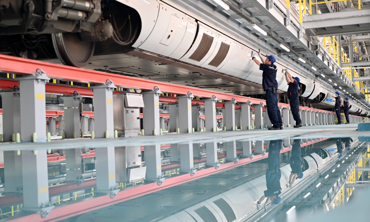 Workers are busy producing smart car navigation systems at a factory in Suqian, East China's Jiangsu Province, on April 9, 2025. According to the China Passenger Car Association, the domestic new-energy vehicle retail penetration rate exceeded 51.1 percent in March, with sales surging 38 percent year-on-year. Photo: VCG