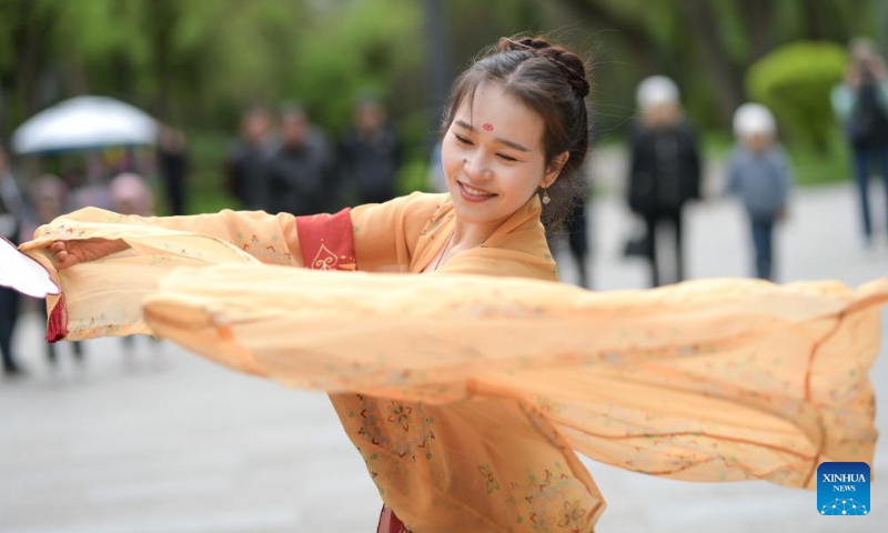A woman in costume with Chinese elements dances at the 2025 International Chinese Language Day event in Almaty, Kazakhstan, April 19, 2025. A celebration event marking the 2025 International Chinese Language Day was held here Saturday, offering an immersive cultural experience that blended Chinese calligraphy, Chinese traditional painting, Hanfu as well as Guzheng (Chinese plucked zither) performance. (Xinhua/Li Renzi)