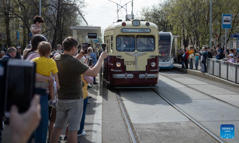 People watch a parade of retro tramways in Moscow, Russia, on April 19, 2025. A parade of retro tramways was held on Saturday to mark the 126th anniversary of the opening of the first tram line in Moscow. (Xinhua/Bai Xueqi)
