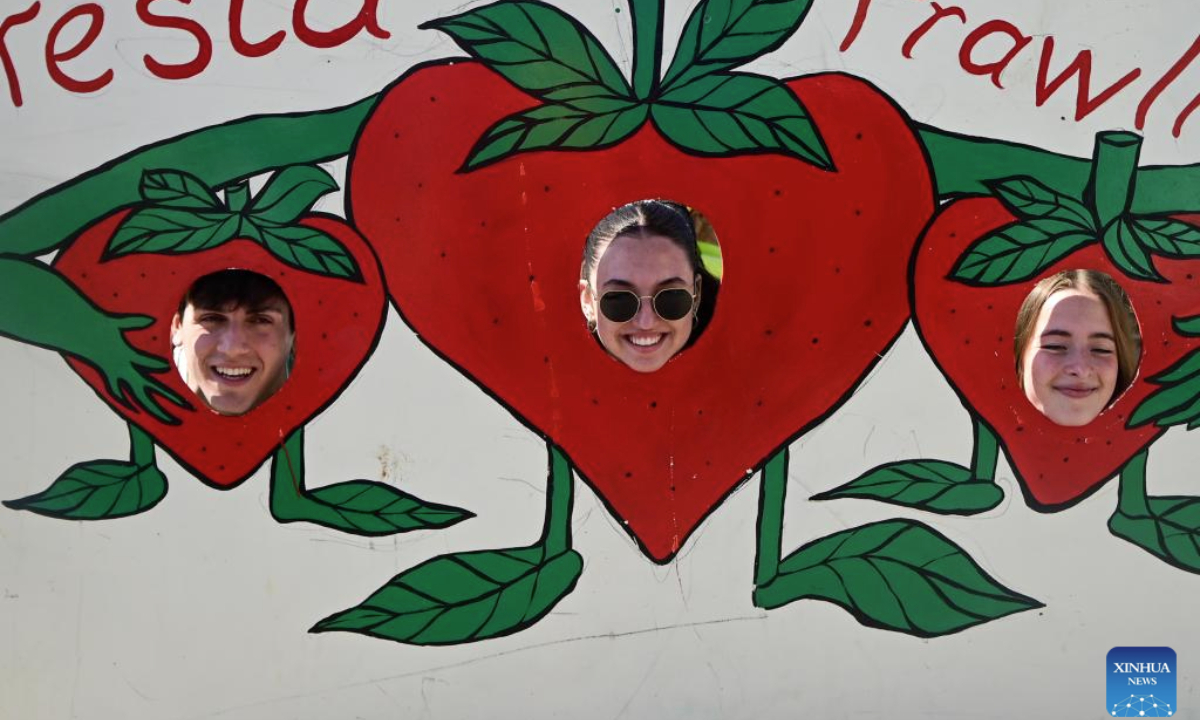 People pose for photos during the strawberry festival in Mgarr, Malta, April 27, 2025. Malta held its annual strawberry festival in Mgarr, a picturesque agricultural village in north Malta on Sunday. (Photo by Jonathan Borg/Xinhua)