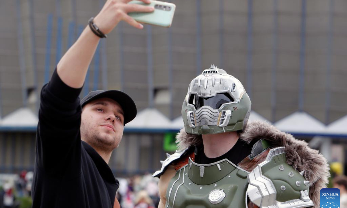 A man takes a selfie with a costumed comic enthusiast during the East European Comic Con festival in Bucharest, Romania, April 27, 2025. Celebrating pop culture, the three-day East European Comic Con festival brought together thousands of fans who love comic books, movies, TV series and gaming. (Photo by Cristian Cristel/Xinhua)