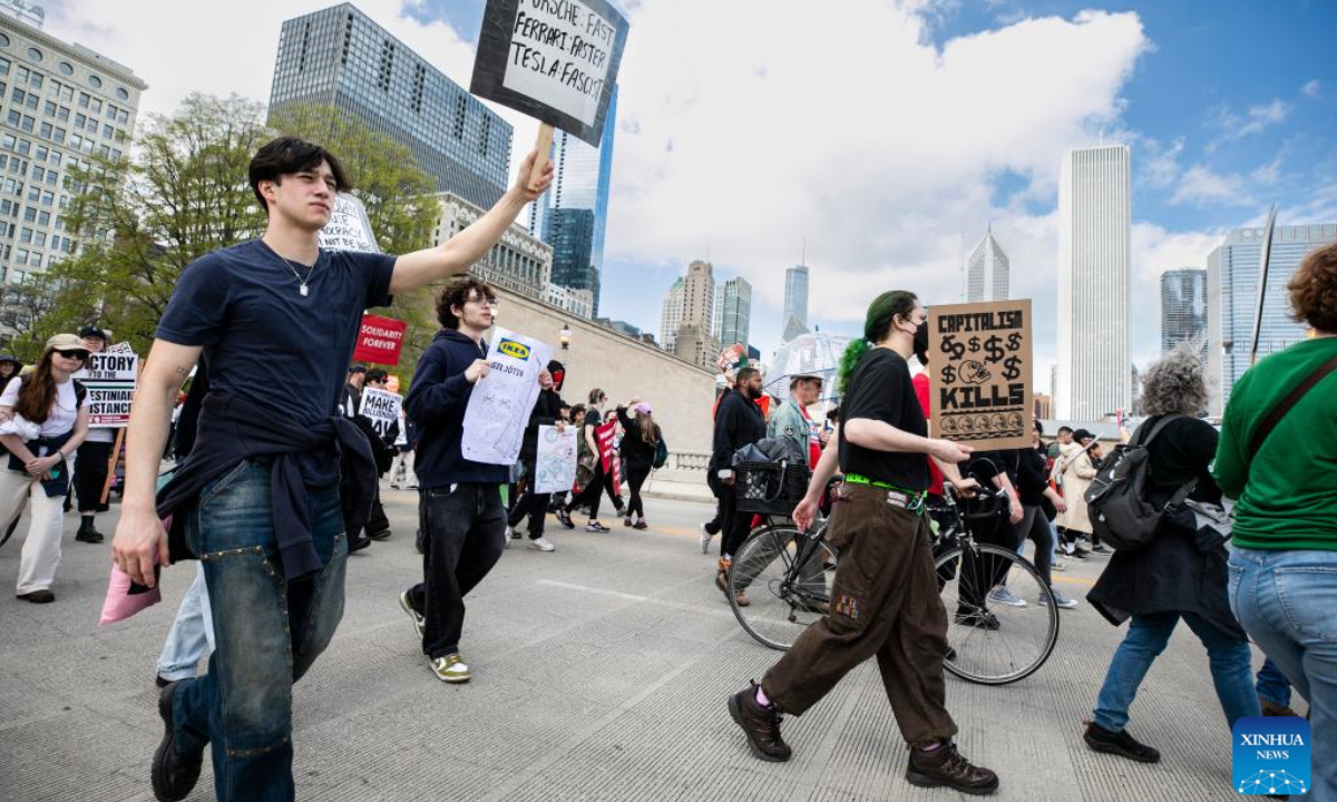 Demonstrators march during a rally in Chicago, the United States, on May 1, 2025. (Photo by Vincent D. Johnson/Xinhua)