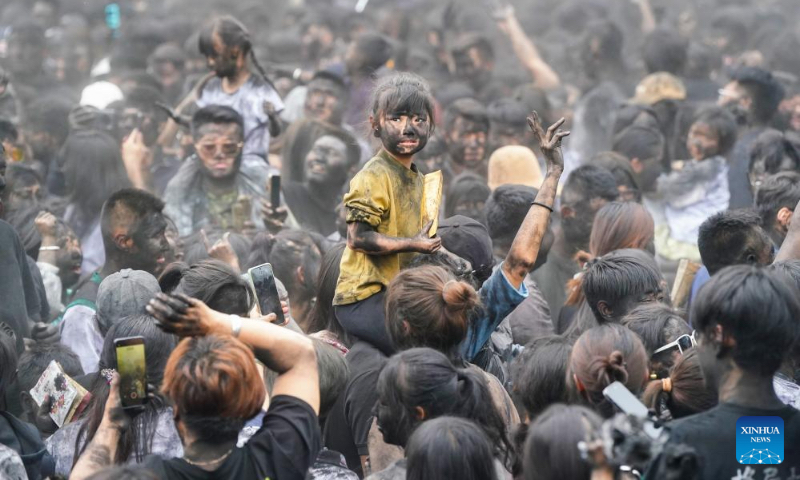 People take part in a folk event called 