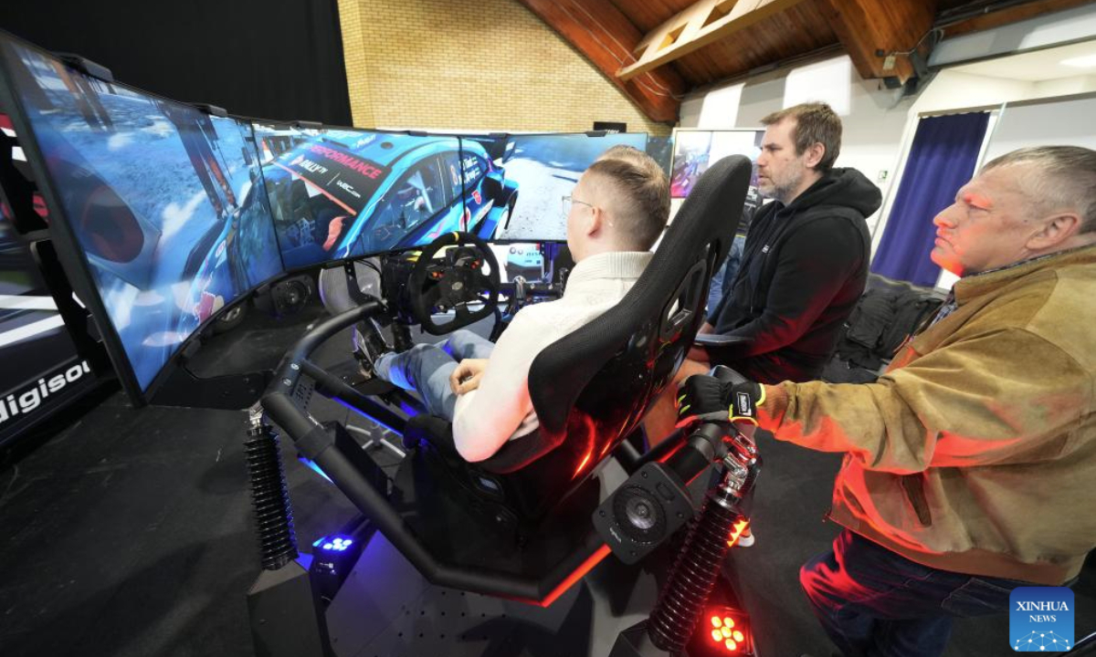 Visitors experience a driving simulator during the Baltic Motor Show Riga Auto 2025 in Riga, Latvia, April 27, 2025. (Photo by Edijs Palens/Xinhua)
