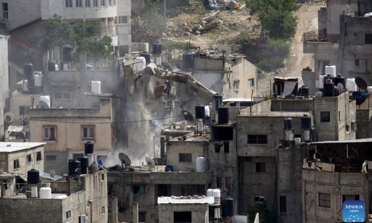 An Israeli excavator demolishes a Palestinian house in the Nur Shams refugee camp, east of Tulkarm, northern West Bank, on May 5, 2025. (Photo by Nidal Eshtayeh/Xinhua)