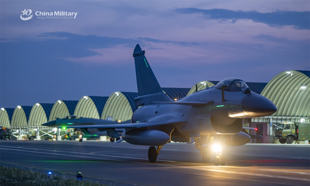 A J-10 fighter jet attached to a unit under the Chinese PLA Air Force taxies out from the hangar for a round-the-clock flight training exercise aimed at beefing up the pilots' combat capability. (eng.chinamil.com.cn/Photo by Xiao Rui)