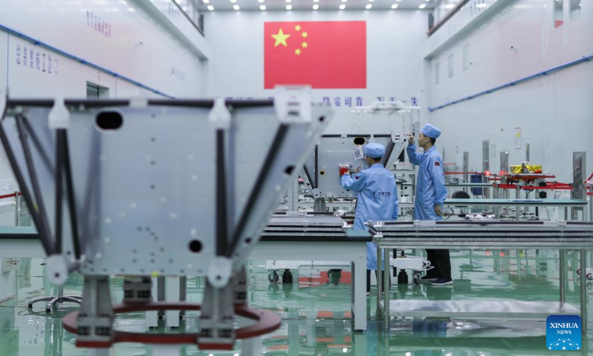 Employees check the assembly of a satellite at a satellite manufacturing base in Hebi, central China's Henan Province, April 21, 2025. Photo:Xinhua