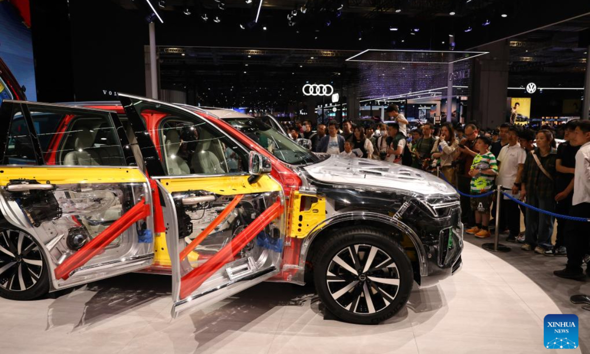Visitors look at a Volvo car on the 21st Shanghai International Automobile Industry Exhibition in east China's Shanghai, May 1, 2025. People visit the auto show here on the first day of the May Day holiday. (Xinhua)