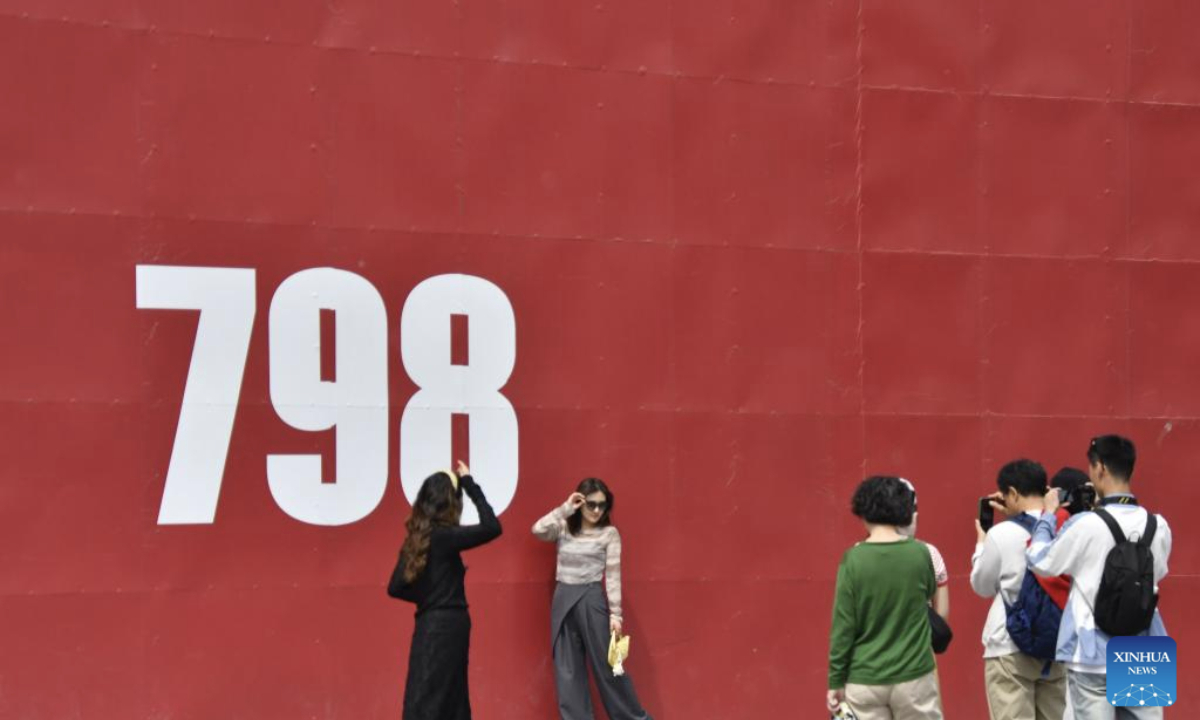  People pose for a photo at the 798 art zone in Beijing, capital of China, May 4, 2025. People across China enjoy the ongoing May Day holiday in various ways. (Xinhua/Li Xin)