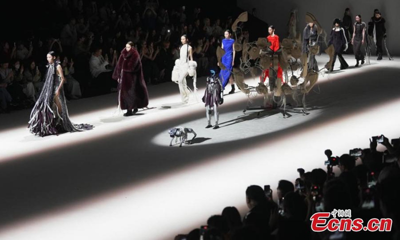 The humanoid robot G1, accompanied by a robotic dog, makes its debut at Shanghai Fashion Week, March 26, 2025. (Photo: China News Service)