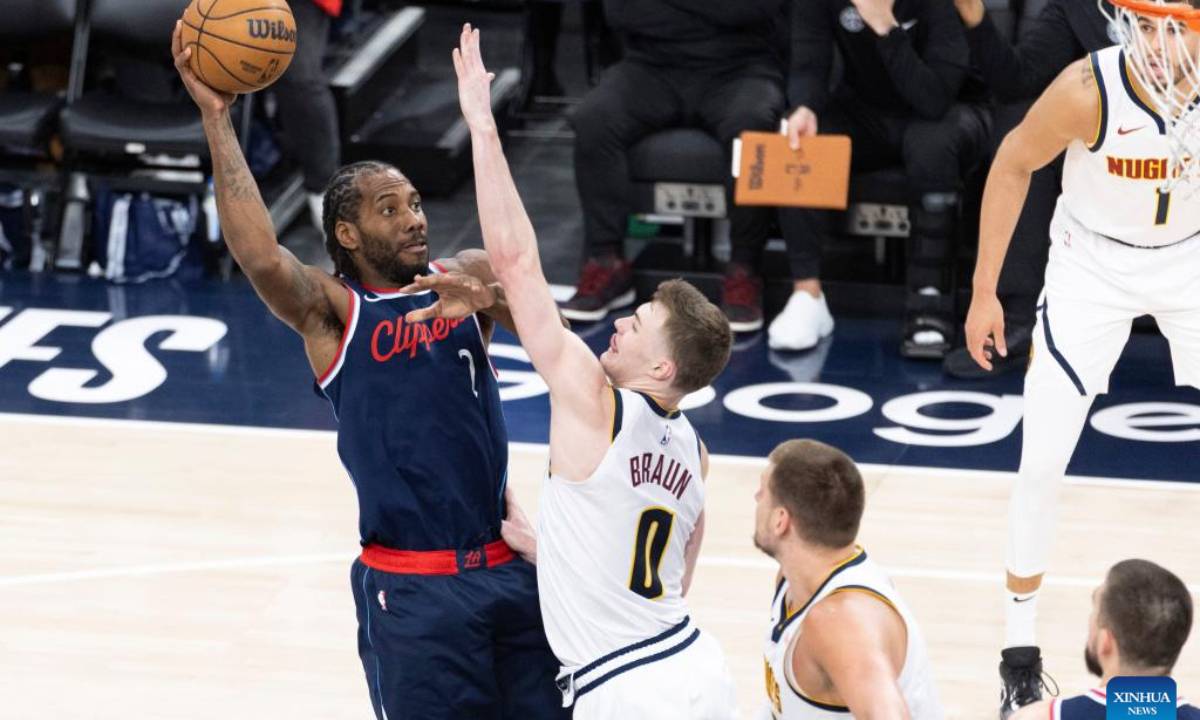 Los Angeles Clippers' Kawhi Leonard (L) shoots against Denver Nuggets' Christian Braun during the 2024-2025 NBA first-round playoff basketball match between Los Angeles Clippers and Denver Nuggets in Los Angeles, the United States, May 1, 2025. (Photo by Ringo Chiu/Xinhua)