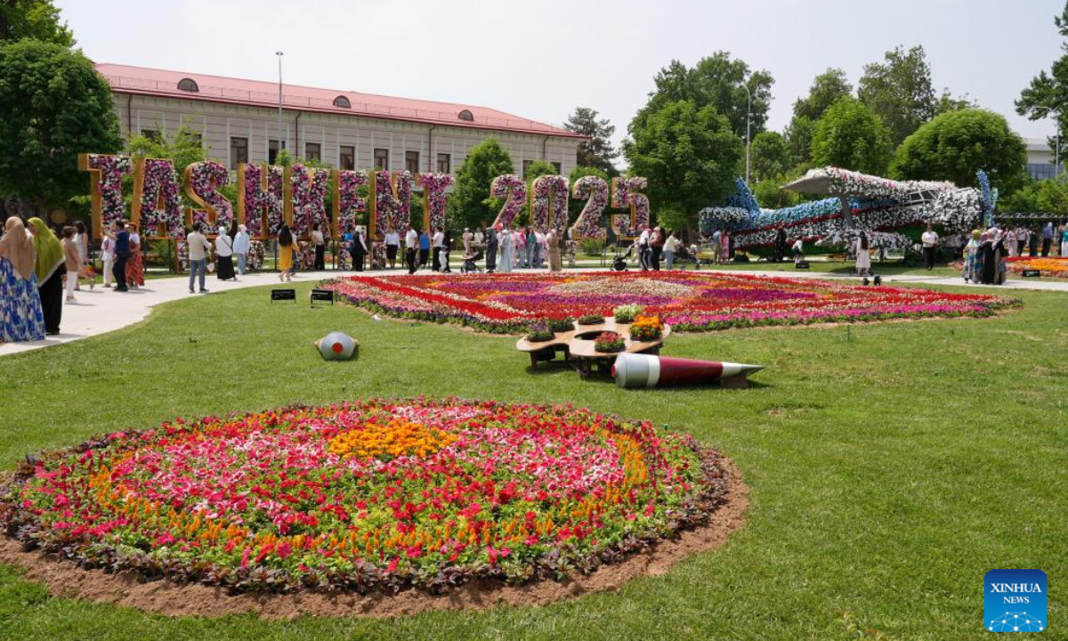 People enjoy floral displays at the square of the National Library of Uzbekistan in Tashkent, Uzbekistan, May 1, 2025. A flower festival is held in Tashkent on Thursday, attracting many local visitors. (Photo by Zafar Khalilov/Xinhua)