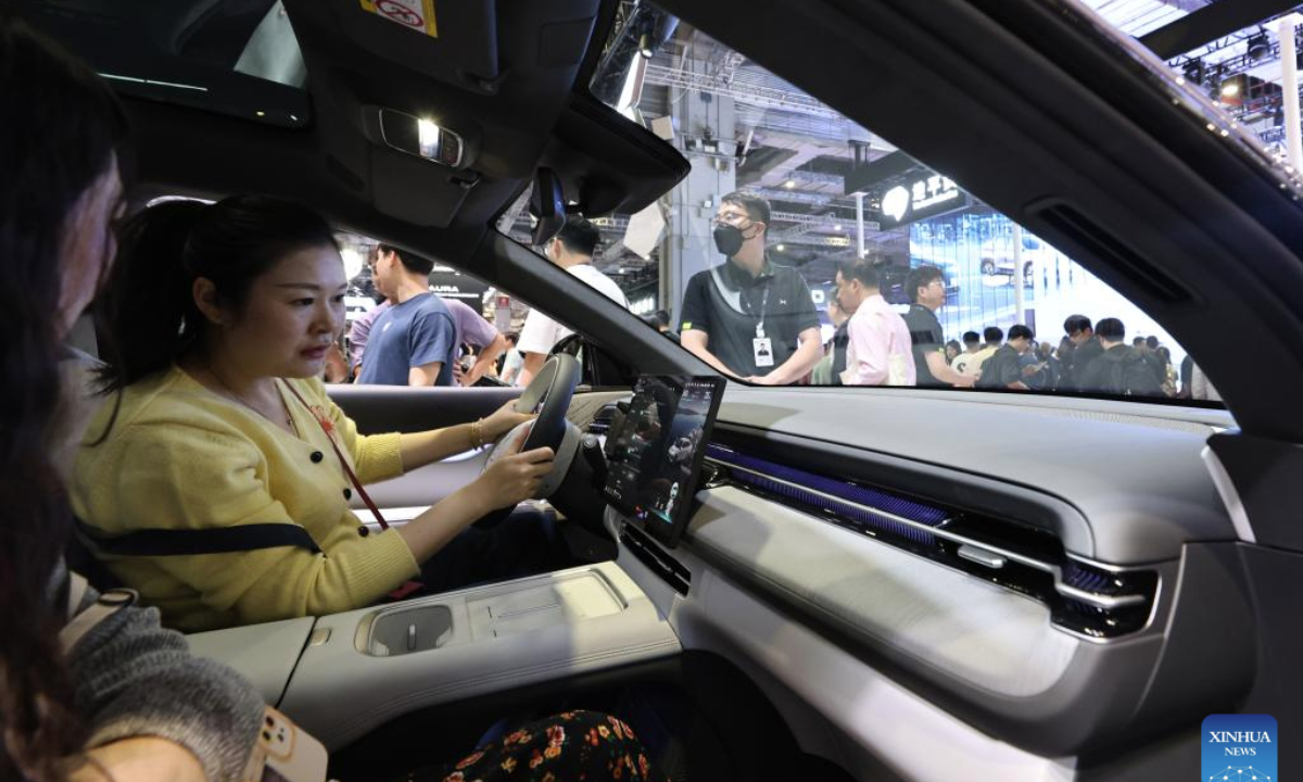Visitors sit in an Xpeng G6 on display at the 21st Shanghai International Automobile Industry Exhibition in east China's Shanghai, April 26, 2025. The exhibition, also known as Auto Shanghai 2025, not only foreshadows technological trends in the global auto market, but also demonstrates the strength and confidence of China's rising automakers in the face of established global giants. (Xinhua/Fang Zhe)