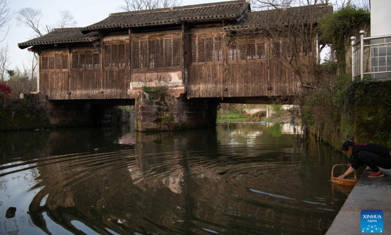 A resident is pictured near the Leshou roofed bridge in Tunxi District of Huangshan City, east China's Anhui Province, April 2, 2025. Roofed bridge, also called covered bridge, is a unique architectural structure in Huangshan City. These ingeniously structured and elegantly shaped bridges carry rich cultural significance and form a distinctive part of Huizhou culture.

In recent years, the city of Huangshan has promoted the inheritance and development of roofed bridge culture through conservation projects, revitalization efforts, and promotional campaigns, attracting an increasing number of visitors to experience the allure of these ancient architectural marvels. (Xinhua/Zhang Duan)