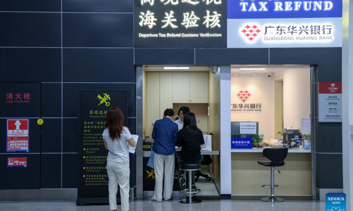 Tourists have their purchases checked at the Wenjindu port in Shenzhen, south China's Guangdong Province, April 30, 2025. To further streamline the departure tax refund process for overseas travelers, Shenzhen launched a new pilot program featuring a