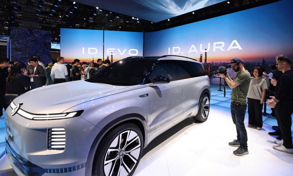A journalist records a Volkswagen ID.AURA on display at the 21st Shanghai International Automobile Industry Exhibition in east China's Shanghai, April 23, 2025. (Xinhua/Fang Zhe)