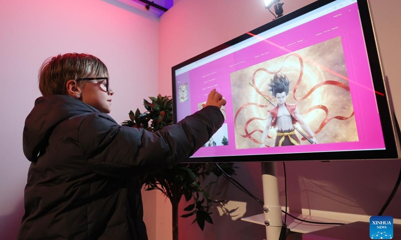 A boy plays a game at the Belgian premiere of Chinese animated film Ne Zha 2 in Brussels, Belgium, March 26, 2025. (Photo: Xinhua)