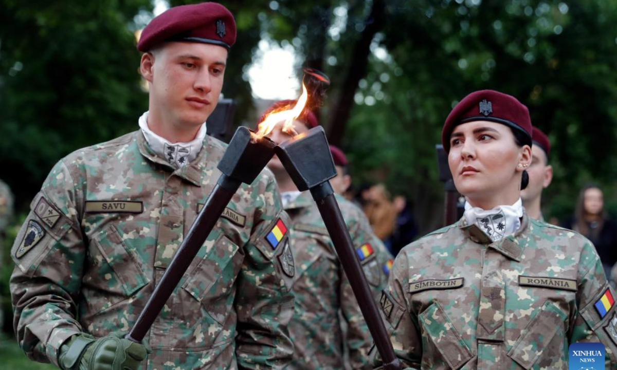 Soldiers light torches before a march to commemorate the Romanian Land Forces Day in Bucharest, Romania, April 27, 2025. (Photo by Cristian Cristel/Xinhua)