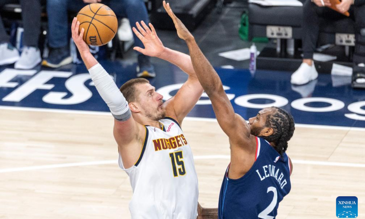 Denver Nuggets' Nikola Jokic (L) shoots against Los Angeles Clippers' Kawhi Leonard during the 2024-2025 NBA first-round playoff basketball match between Los Angeles Clippers and Denver Nuggets in Los Angeles, the United States, May 1, 2025. (Photo by Ringo Chiu/Xinhua)
