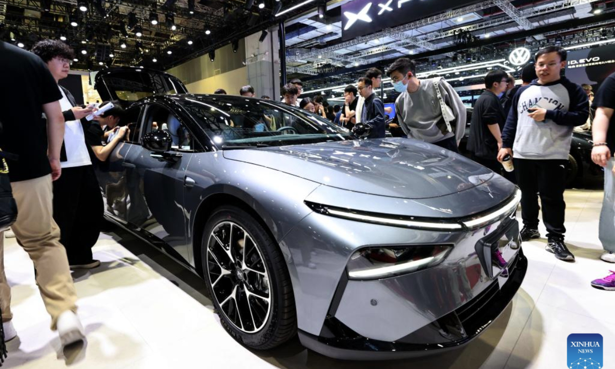 Visitors look at an Xpeng P7+ on display at the 21st Shanghai International Automobile Industry Exhibition in east China's Shanghai, April 26, 2025. The exhibition, also known as Auto Shanghai 2025, not only foreshadows technological trends in the global auto market, but also demonstrates the strength and confidence of China's rising automakers in the face of established global giants. (Xinhua/Fang Zhe)