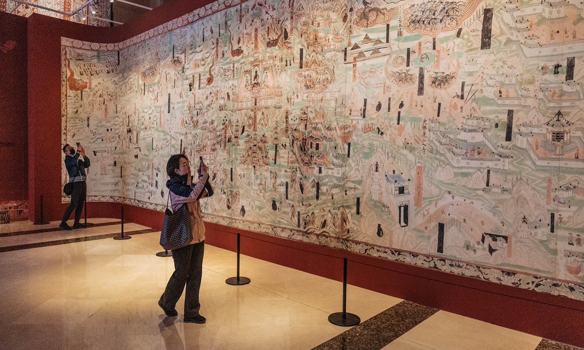 Visitors explore the Dunhuang Culture & Art Exhibition at the Beijing Exhibition Center on March 27, 2025 in Beijing. The largest themed exhibition for the Mogao Grottoes, a UNESCO World Heritage site boasting rich collections of Buddhist artworks in Dunhuang, Northwest China's Gansu Province, will formally open to the public on Saturday. Photo: Li Hao/Global Time
