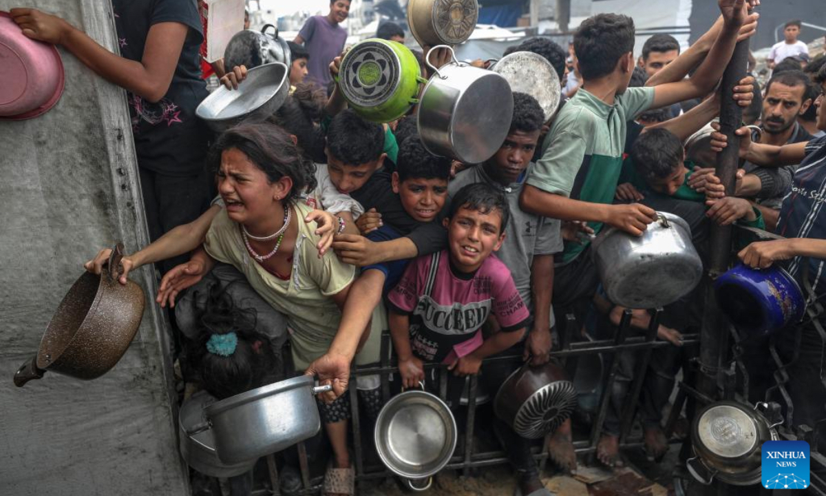 Palestinians wait to receive free food from a food distribution center in Gaza City, on April 24, 2025. As regional and international mediation intensifies to reach a lasting ceasefire in the Gaza Strip, many Palestinians are expressing cautious hope that current diplomatic efforts will result in sustainable peace and relief for their war-affected communities. (Photo: Xinhua)