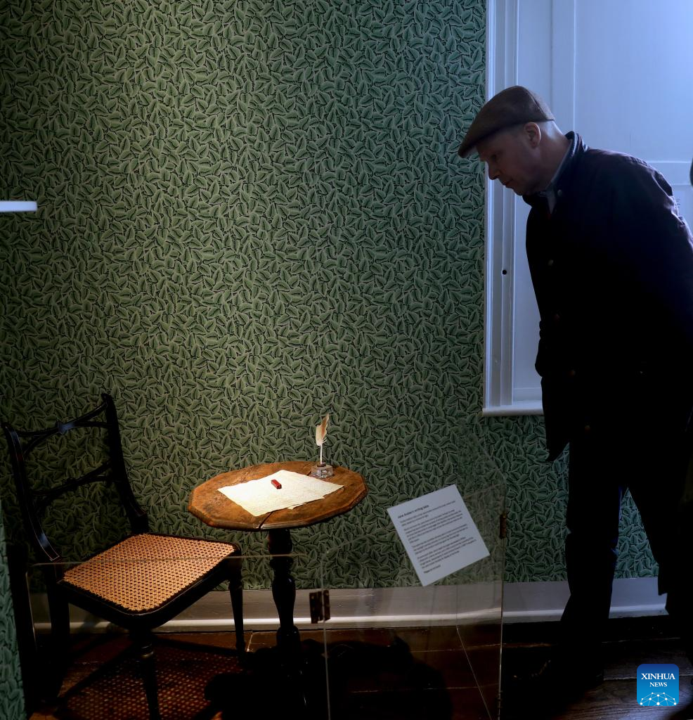 A man looks at the tiny writing table at which Jane Austen wrote at Jane Austen's House in Chawton, Hampshire, Britain, April 18, 2025. As her final home, English female novelist Jane Austen lived in this cottage in Chawton for the last eight years of her life. Here she wrote, revised and published all six of her globally beloved novels: Sense and Sensibility, Pride and Prejudice, Mansfield Park, Emma, Northanger Abbey and Persuasion. (Xinhua)