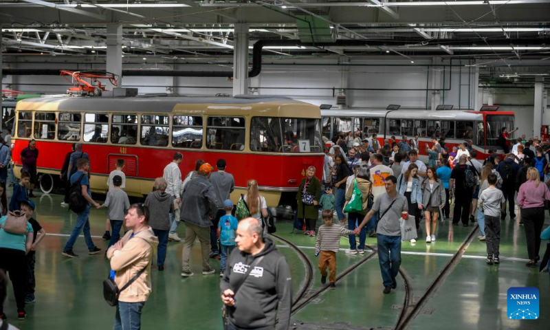 People look at trams at a depot in Moscow, Russia, on April 19, 2025. A parade of retro tramways was held on Saturday to mark the 126th anniversary of the opening of the first tram line in Moscow. (Photo by Alexander Zemlianichenko Jr/Xinhua)