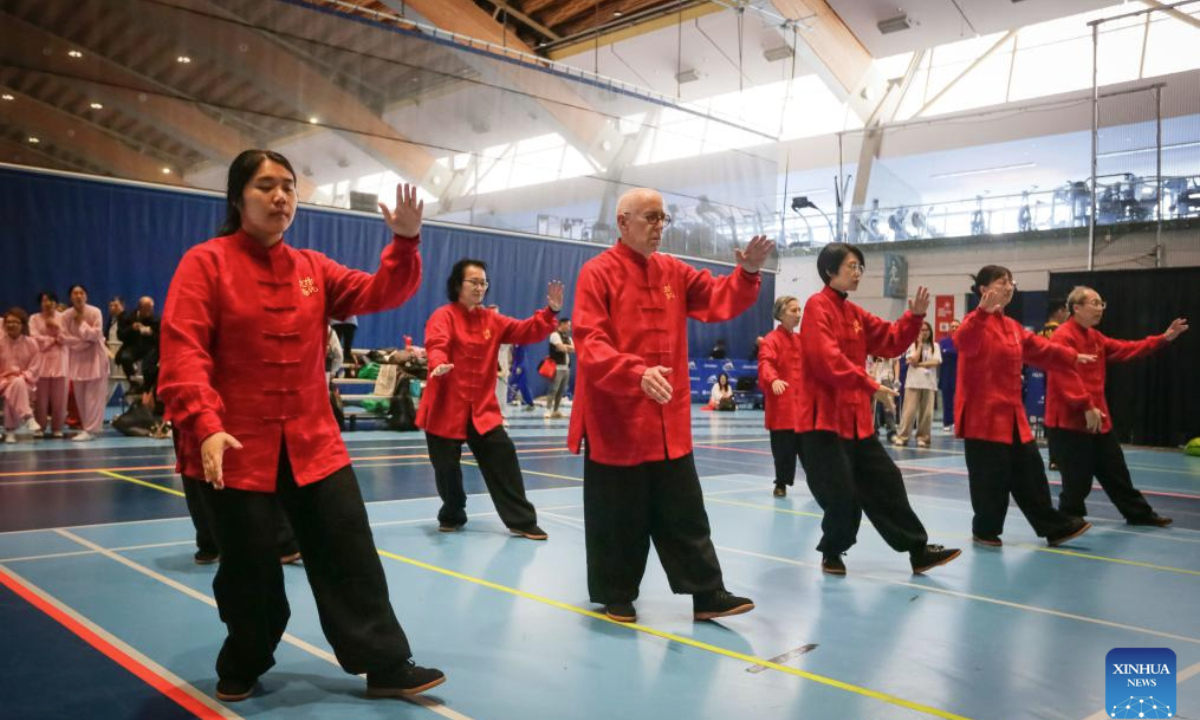 People demonstrate Tai Chi together to celebrate World Tai Chi Day during the 2025 Can-Am Martial Arts Championships in Richmond, British Columbia, Canada, April 26, 2025. The World Tai Chi Day falls on the last Saturday of April. (Photo by Liang Sen/Xinhua)