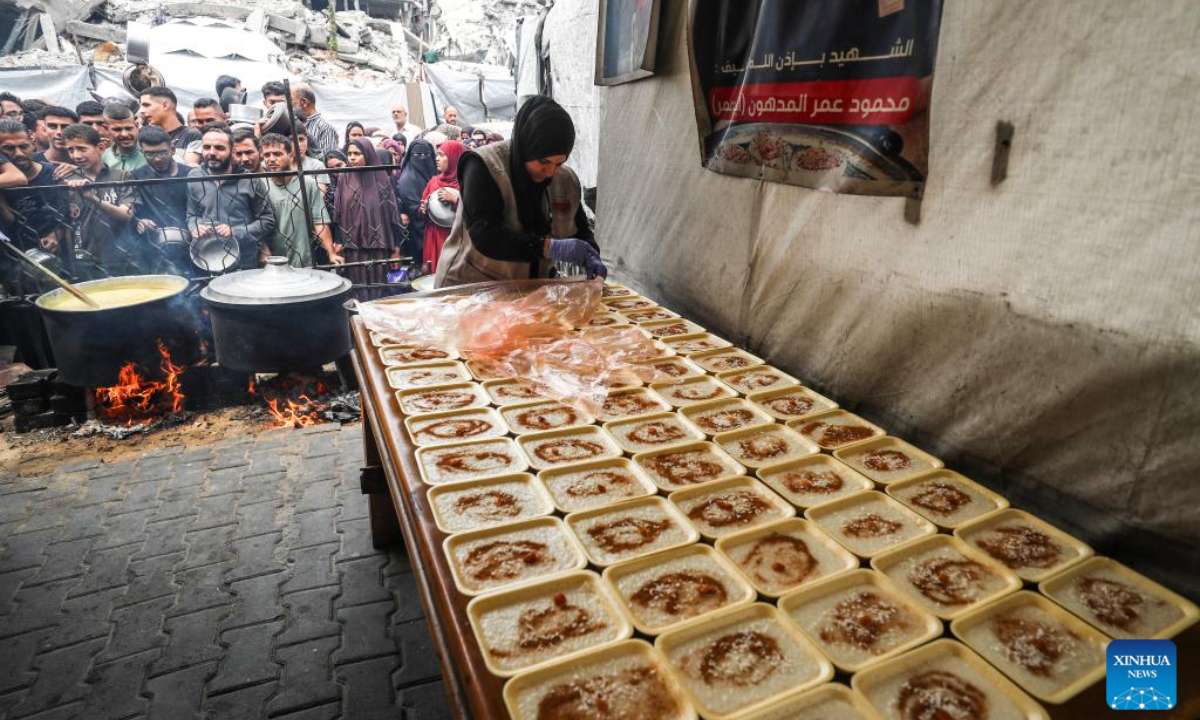 Palestinians wait to receive free food from a food distribution center in Gaza City, on April 24, 2025. As regional and international mediation intensifies to reach a lasting ceasefire in the Gaza Strip, many Palestinians are expressing cautious hope that current diplomatic efforts will result in sustainable peace and relief for their war-affected communities. (Photo: Xinhua)