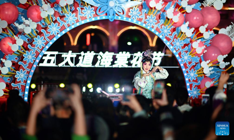 An artist performs during the launch event of a crabapple blossom festival at the Wudadao historical urban area in north China's Tianjin, April 3, 2025. The third edition of a crabapple blossom festival kicked off on Thursday at Wudadao historical urban area, a popular tourist destination in the downtown area of Tianjin. The festival, which stays on until April 13, features more than 100 art and culture performances to enable 