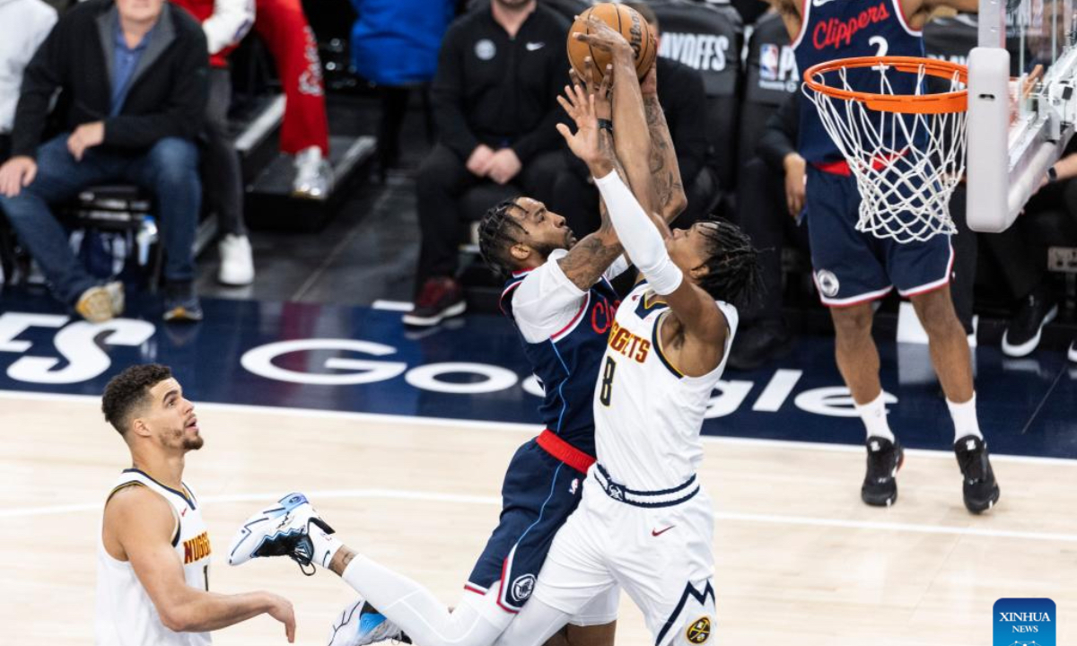 Los Angeles Clippers' Derrick Jones Jr. (C) goes to the basket against Denver Nuggets' Peyton Watson during the 2024-2025 NBA first-round playoff basketball match between Los Angeles Clippers and Denver Nuggets in Los Angeles, the United States, May 1, 2025. (Photo by Ringo Chiu/Xinhua)