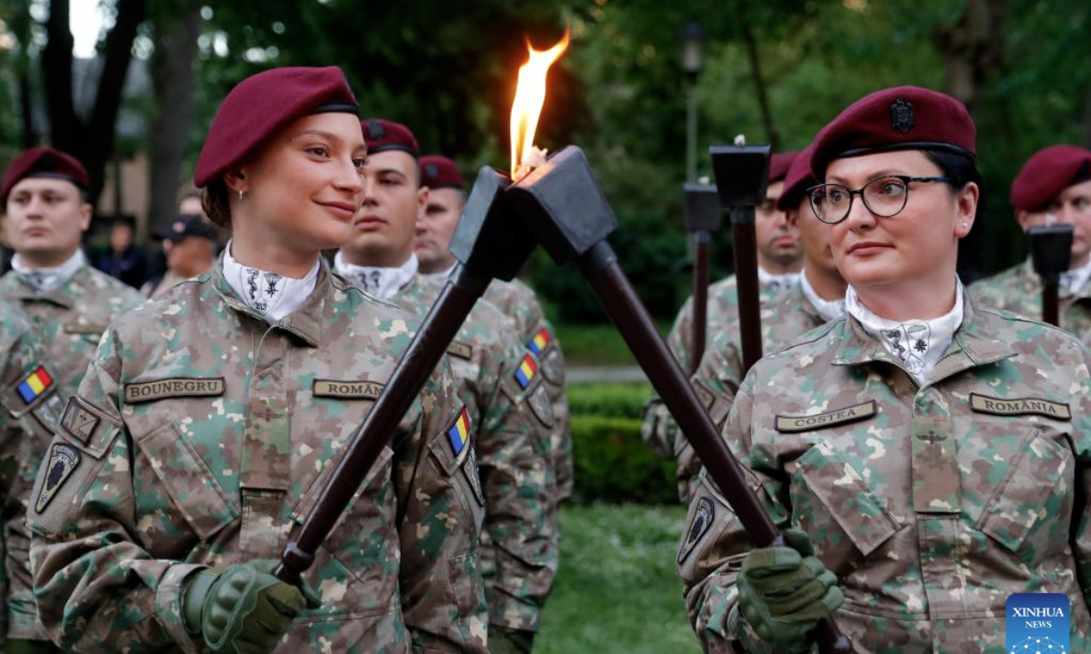 Soldiers light torches before a march to commemorate the Romanian Land Forces Day in Bucharest, Romania, April 27, 2025. (Photo by Cristian Cristel/Xinhua)