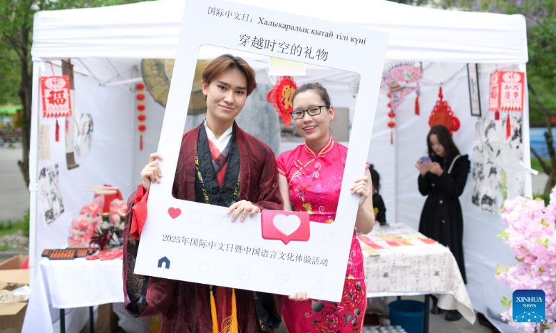 People in costumes with Chinese elements pose for photos at the 2025 International Chinese Language Day event in Almaty, Kazakhstan, April 19, 2025. A celebration event marking the 2025 International Chinese Language Day was held here Saturday, offering an immersive cultural experience that blended Chinese calligraphy, Chinese traditional painting, Hanfu as well as Guzheng (Chinese plucked zither) performance. (Xinhua/Li Renzi)