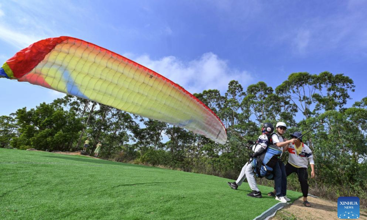 A tourist enjoys paragliding in Lingshui Li Autonomous County, south China's Hainan Province, May 3, 2025. Low-altitude tourism activities such as paragliding and parachuting have become trendy among tourists to China's island province of Hainan during the May Day holiday. (Xinhua/Guo Cheng)