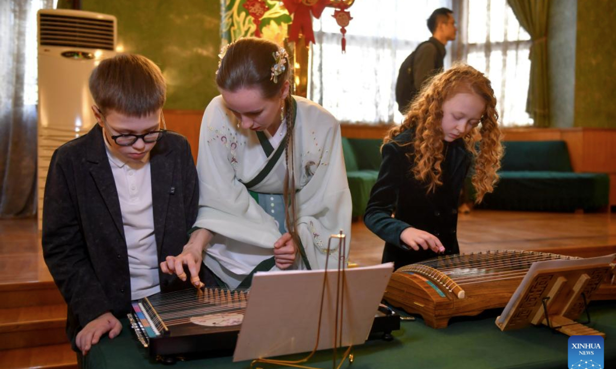 Children try traditional Chinese musical instruments at the 2025 International Chinese Language Day event in Moscow, Russia, April 20, 2025. (Photo by Alexander Zemlianichenko Jr/Xinhua)