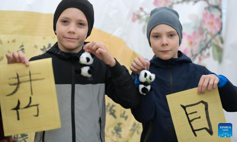 Boys show their Chinese calligraphy works at the 2025 International Chinese Language Day event in Almaty, Kazakhstan, April 19, 2025. A celebration event marking the 2025 International Chinese Language Day was held here Saturday, offering an immersive cultural experience that blended Chinese calligraphy, Chinese traditional painting, Hanfu as well as Guzheng (Chinese plucked zither) performance. (Xinhua/Li Renzi)