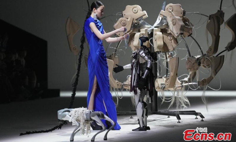 The humanoid robot G1, accompanied by a robotic dog, makes its debut at Shanghai Fashion Week, March 26, 2025. (Photo: China News Service)
