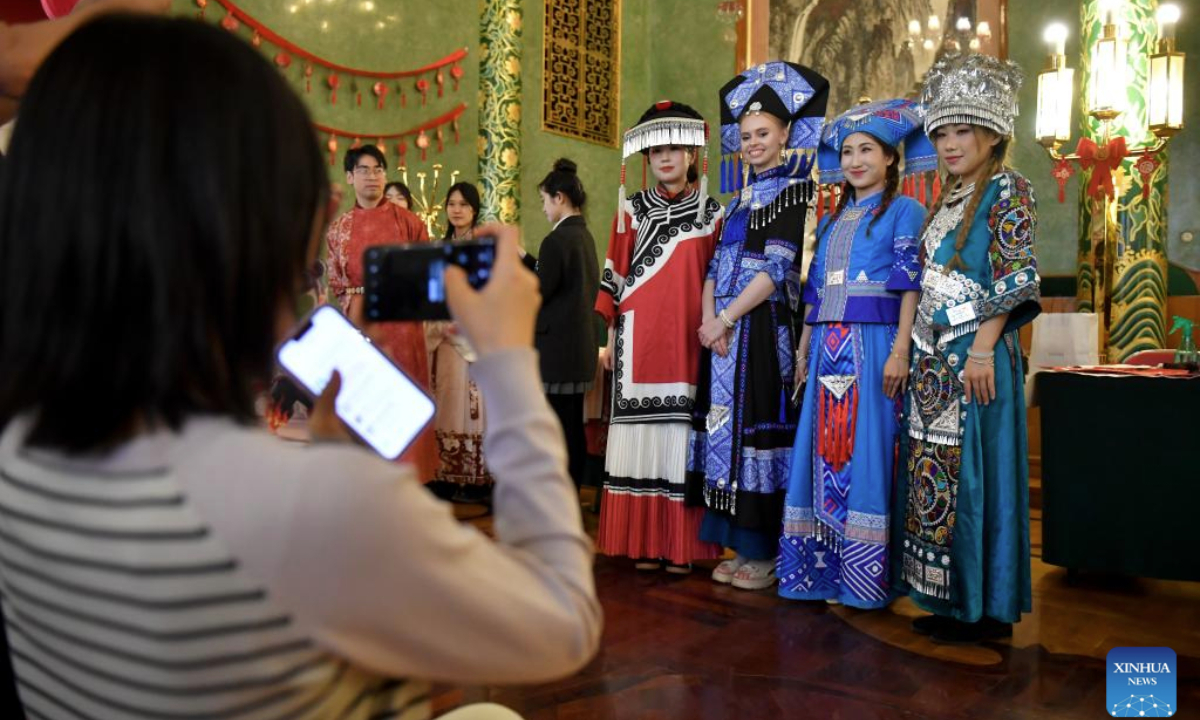 Students in Chinese ethnic costumes pose for photos at the 2025 International Chinese Language Day event in Moscow, Russia, April 20, 2025. (Photo by Alexander Zemlianichenko Jr/Xinhua)