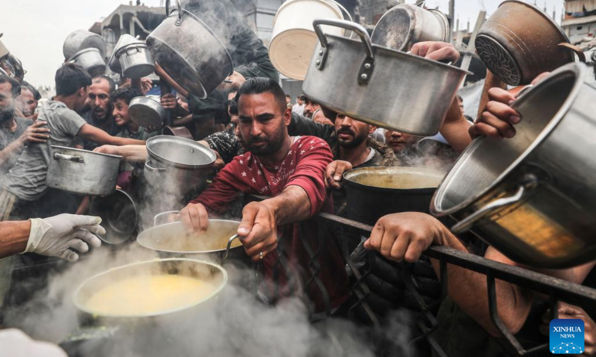 Palestinians receive free food from a food distribution center in Gaza City, on April 24, 2025. As regional and international mediation intensifies to reach a lasting ceasefire in the Gaza Strip, many Palestinians are expressing cautious hope that current diplomatic efforts will result in sustainable peace and relief for their war-affected communities. (Photo: Xinhua)