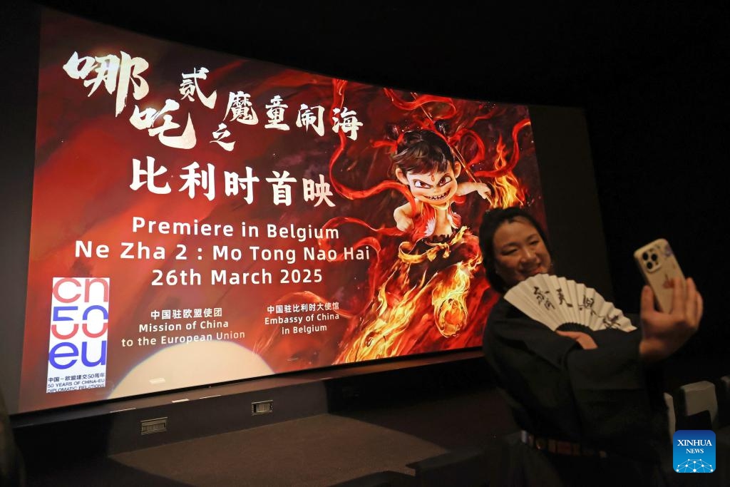A woman takes selfies at the Belgian premiere of Chinese animated film Ne Zha 2 in Brussels, Belgium, March 26, 2025. (Photo: Xinhua)