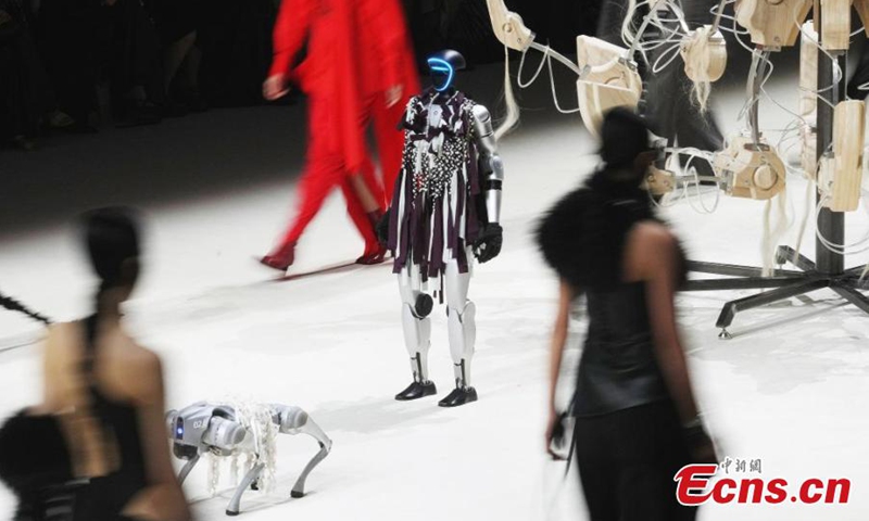 The humanoid robot G1, accompanied by a robotic dog, makes its debut at Shanghai Fashion Week, March 26, 2025. (Photo: China News Service)
