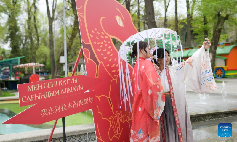 People in costumes with Chinese elements take selfies at the 2025 International Chinese Language Day event in Almaty, Kazakhstan, April 19, 2025. A celebration event marking the 2025 International Chinese Language Day was held here Saturday, offering an immersive cultural experience that blended Chinese calligraphy, Chinese traditional painting, Hanfu as well as Guzheng (Chinese plucked zither) performance. (Xinhua/Li Renzi)