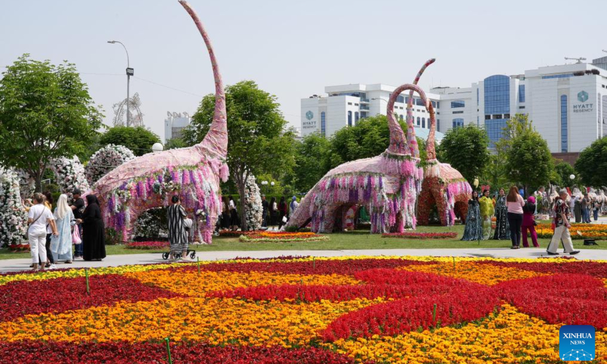 People enjoy floral displays at the square of the National Library of Uzbekistan in Tashkent, Uzbekistan, May 1, 2025. A flower festival is held in Tashkent on Thursday, attracting many local visitors. (Photo by Zafar Khalilov/Xinhua)