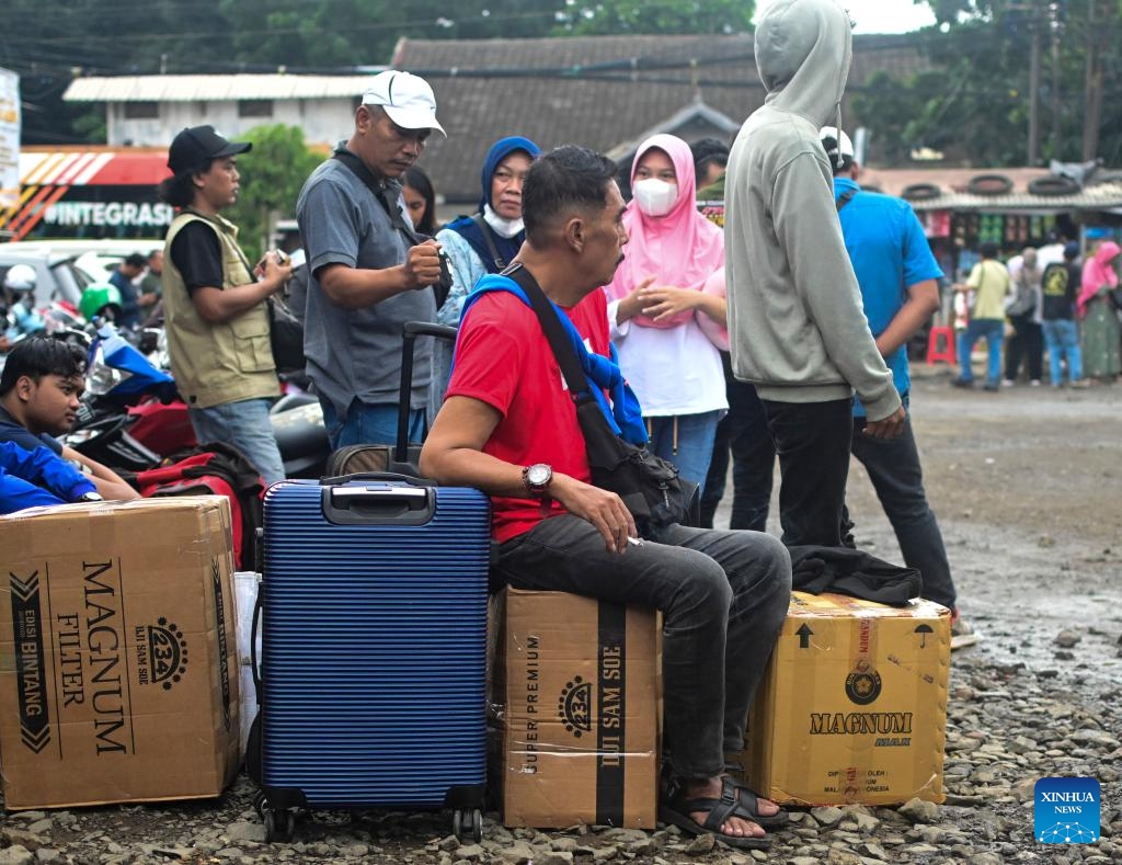 Passengers wait at a bus station ahead of the Eid al-Fitr festival in Jakarta, Indonesia, March 27, 2025. During Indonesia's Eid homecoming season, known as mudik, Jakarta residents leave the city where they live and work to visit their hometowns and celebrate the holiday with extended family. (Photo: Xinhua)
