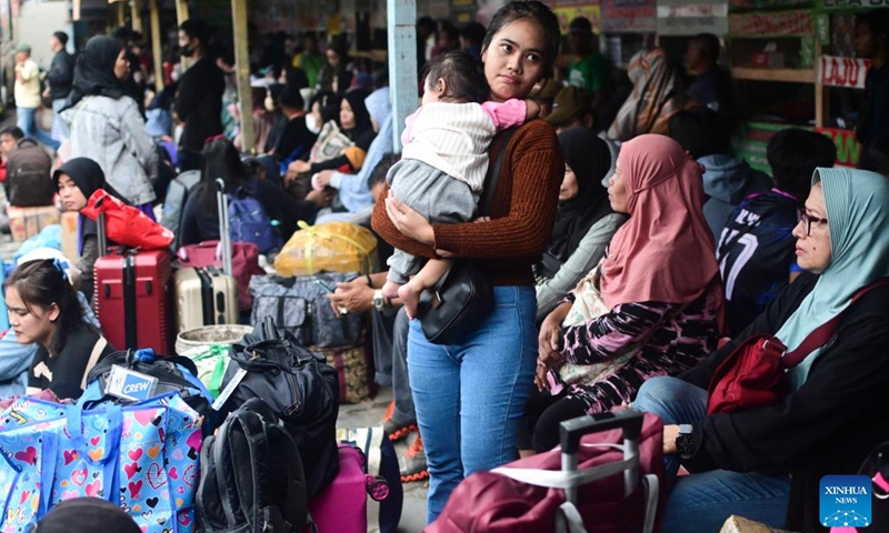 Passengers wait at a bus station ahead of the Eid al-Fitr festival in Jakarta, Indonesia, March 27, 2025. During Indonesia's Eid homecoming season, known as mudik, Jakarta residents leave the city where they live and work to visit their hometowns and celebrate the holiday with extended family. (Photo: Xinhua)
