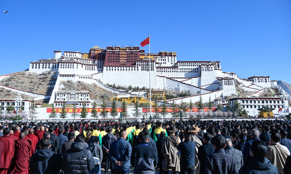 People attend a flag-raising ceremony to celebrate the Serfs' Emancipation Day at the square in front of the Potala Palace in Lhasa, capital of Southwest China's Xizang Autonomous Region, on March 28, 2025.?Photo: VCG