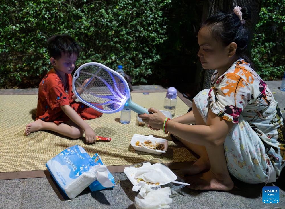 A woman uses an electric swatter to swat mosquitoes in Mandalay, Myanmar, March 31, 2025. The weather in Mandalay is hot recently, and the temperature can reach 40 degrees Celsius during the day. (Photo: Xinhua)