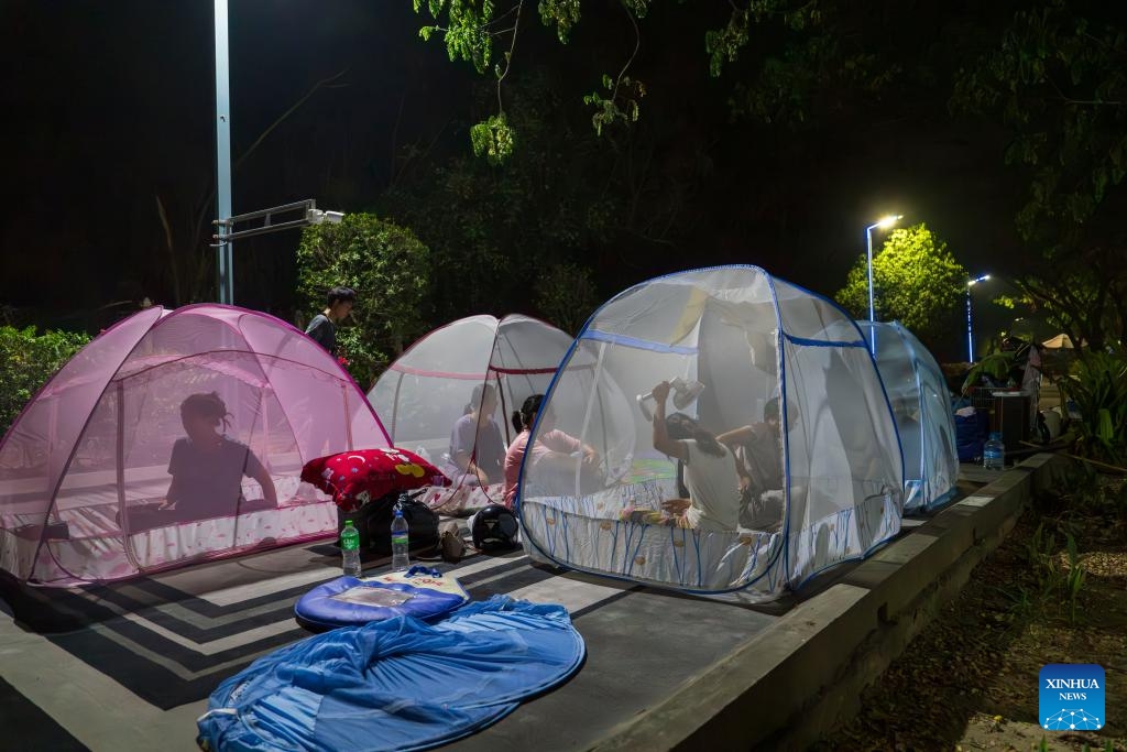 People rest in mosquito nets in Mandalay, Myanmar, March 31, 2025. The weather in Mandalay is hot recently, and the temperature can reach 40 degrees Celsius during the day. (Photo: Xinhua)